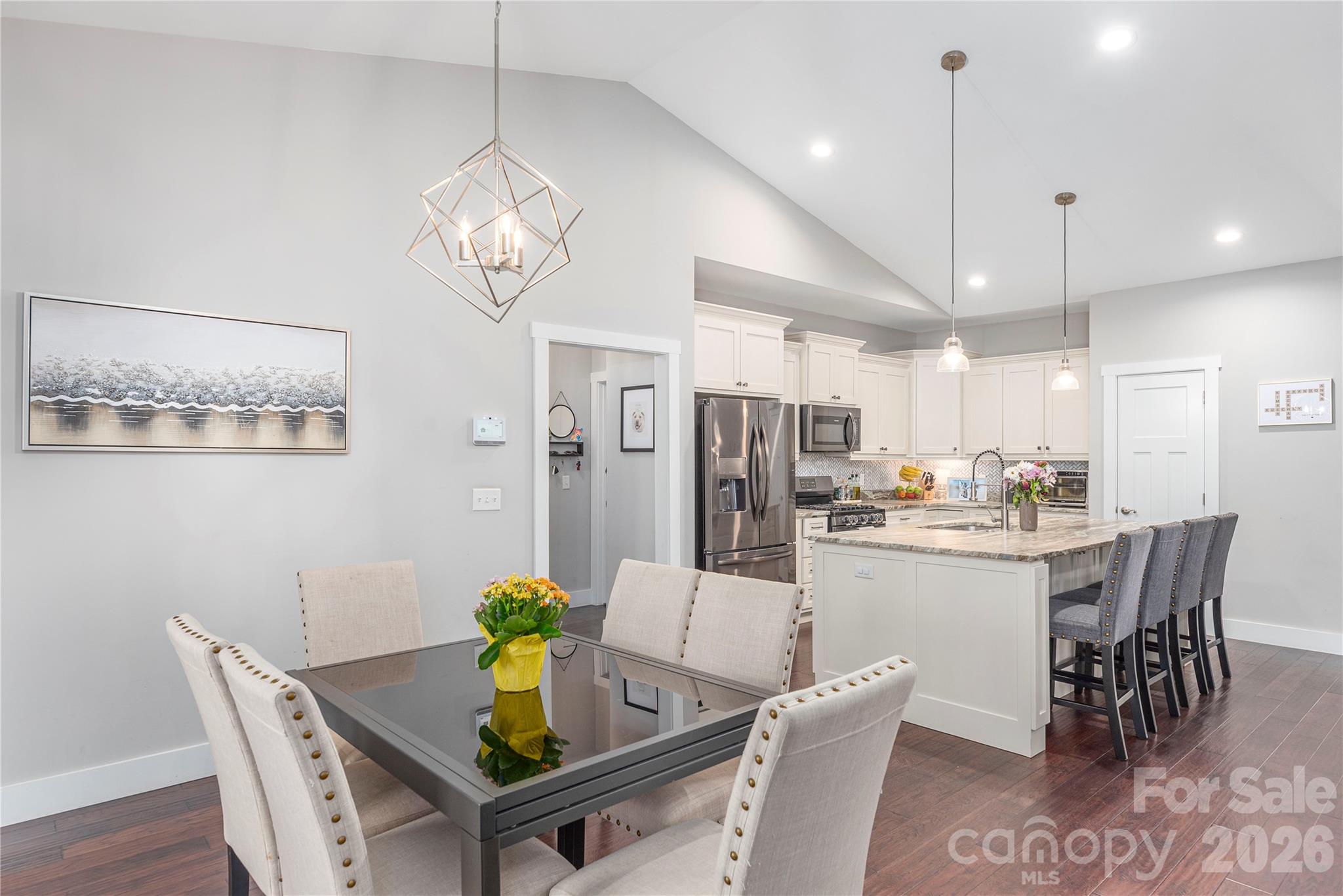 348 Olivet Lane Fletcher, NC 28732 - Photo 11 of 39 a dining room with stainless steel appliances kitchen island a table chairs and a chandelier