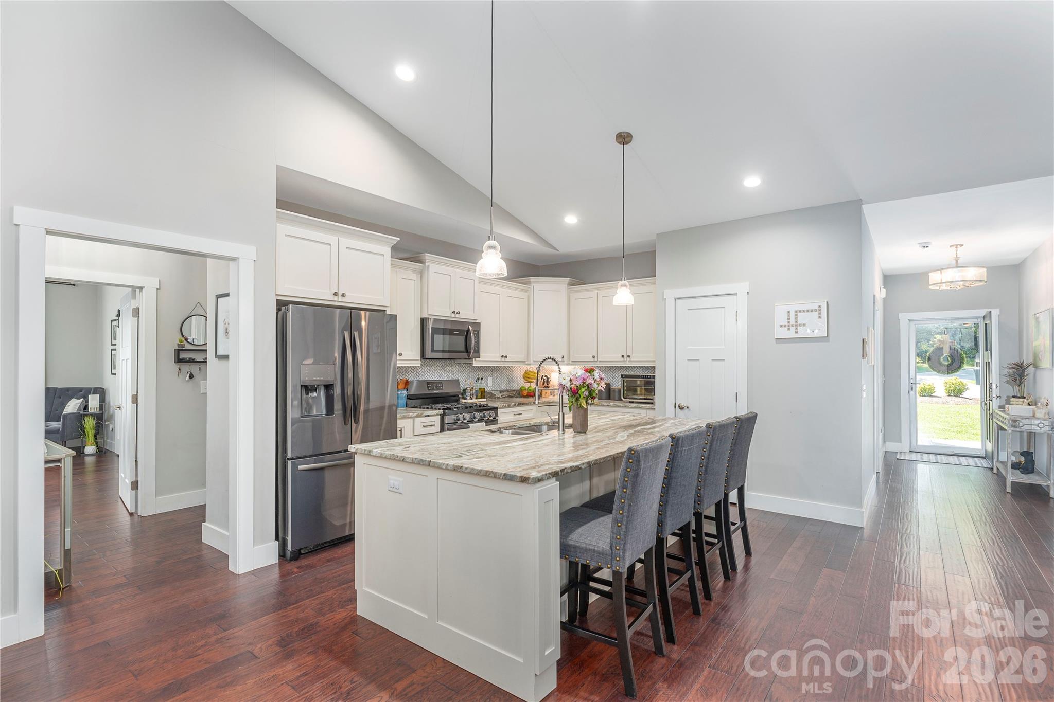 348 Olivet Lane Fletcher, NC 28732 - Photo 12 of 39 a kitchen with a dining table chairs refrigerator and microwave