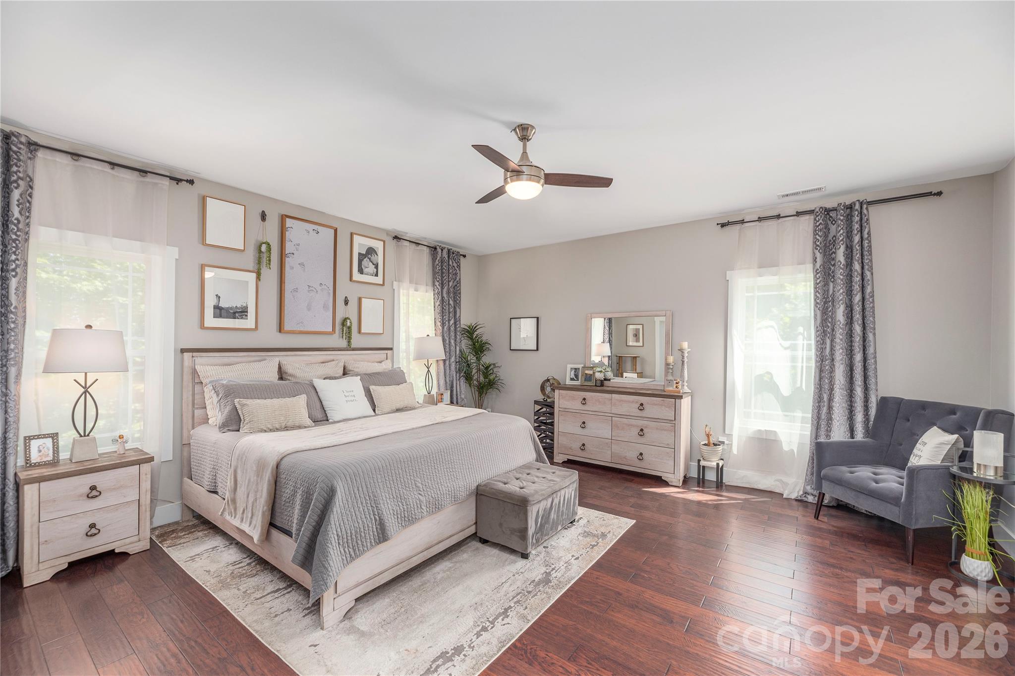 348 Olivet Lane Fletcher, NC 28732 - Photo 19 of 39 a bedroom with a large bed and wooden floor