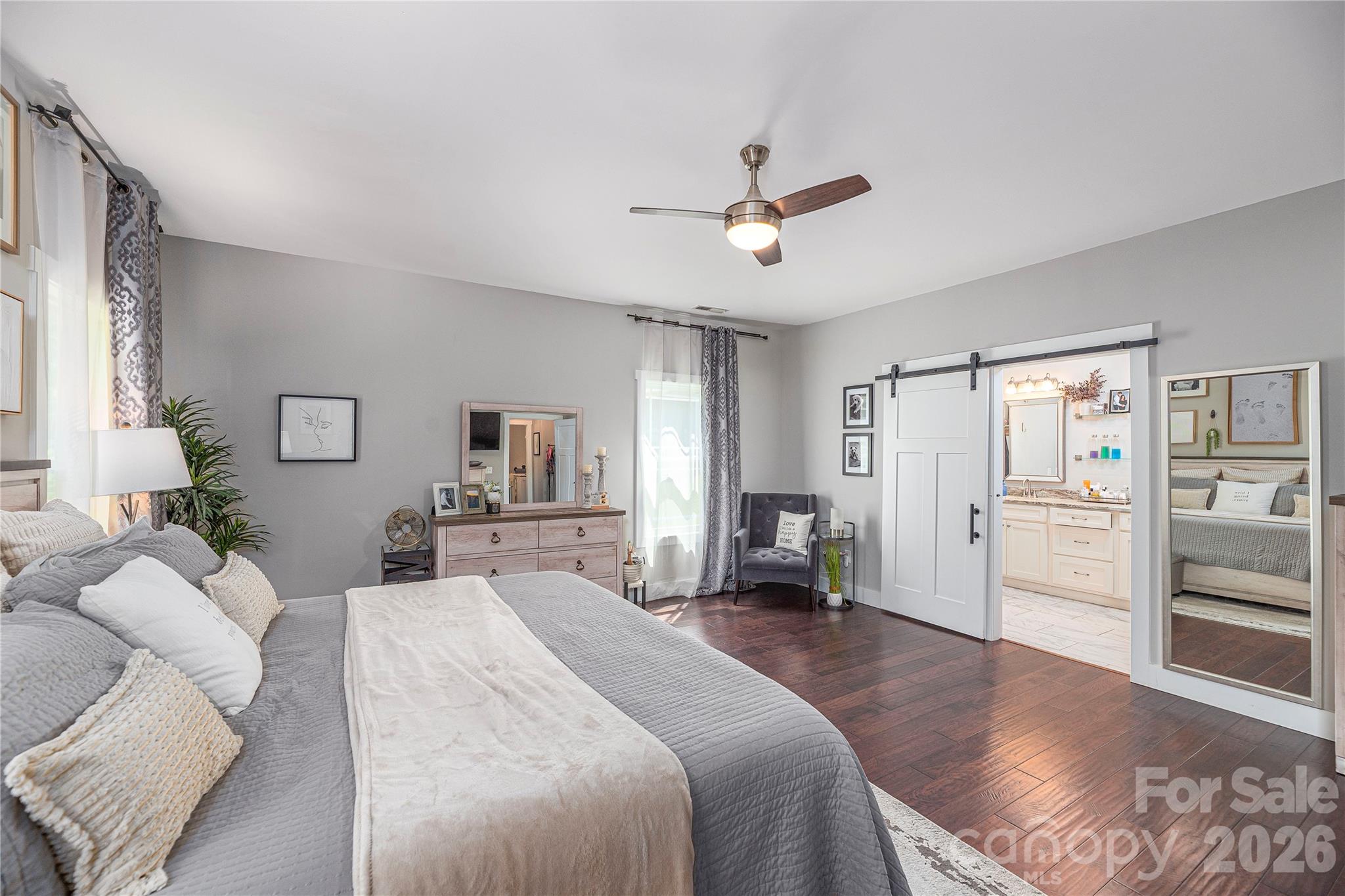 348 Olivet Lane Fletcher, NC 28732 - Photo 19 of 39 a spacious bedroom with a bed and ceiling fan