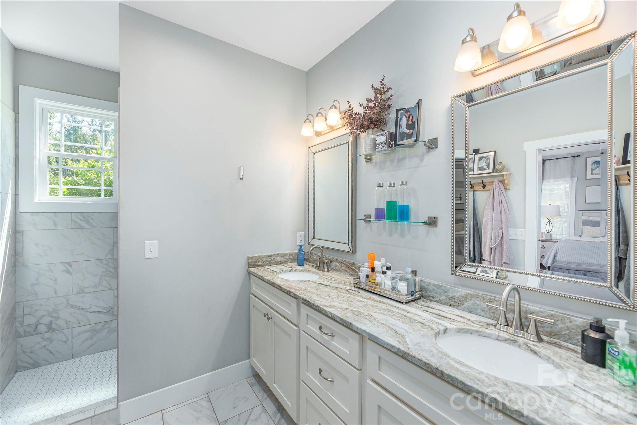 348 Olivet Lane Fletcher, NC 28732 - Photo 20 of 39 a bathroom with a granite countertop sink a mirror and a shower