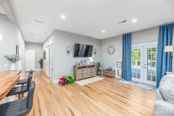 a room with a bed and a flat screen tv