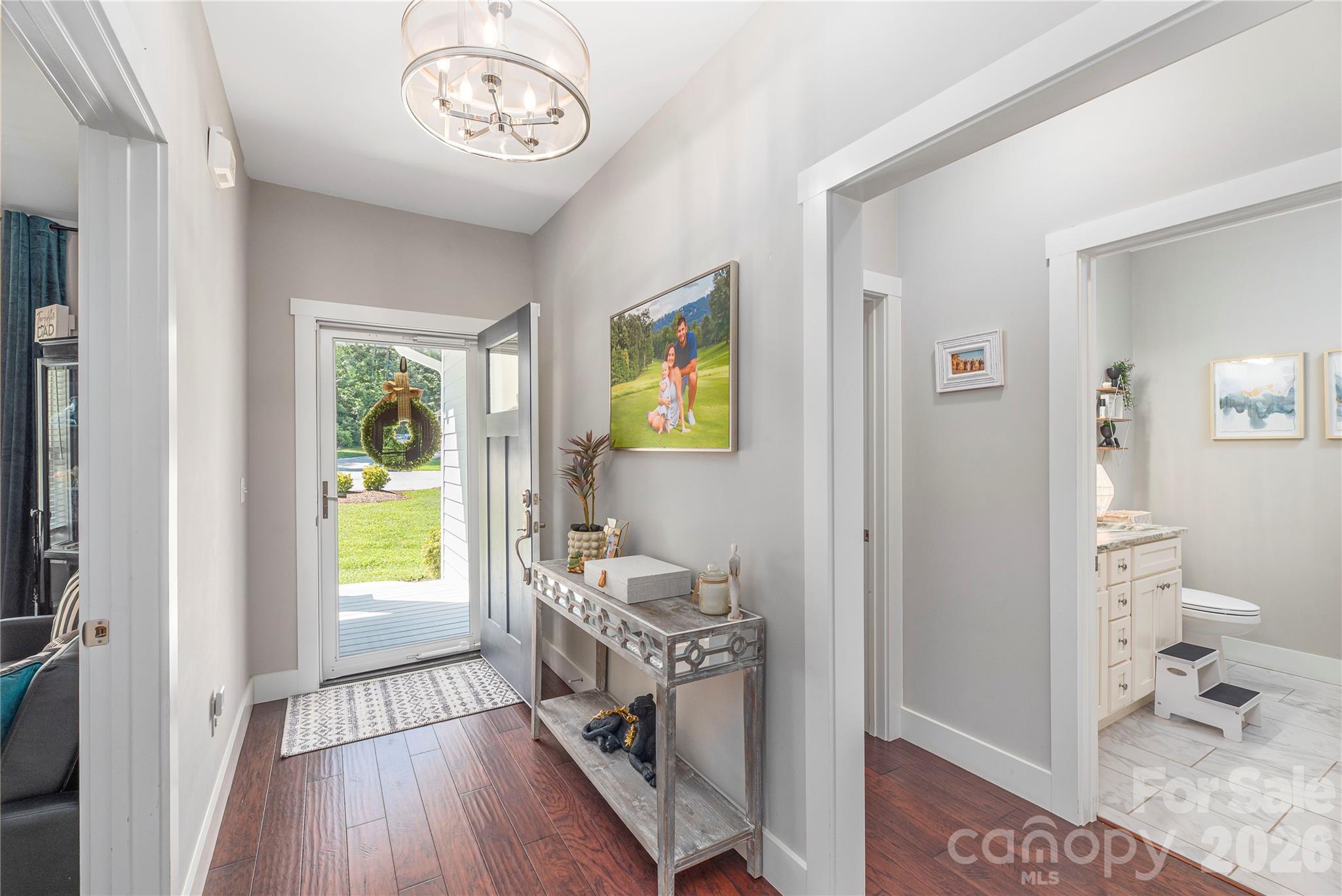348 Olivet Lane Fletcher, NC 28732 - Photo 3 of 39 a view of a hallway to a livingroom and a dining room with furniture