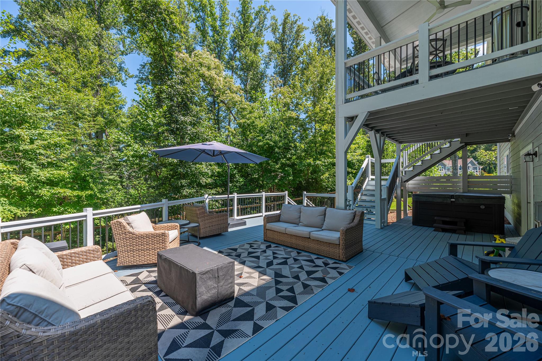 348 Olivet Lane Fletcher, NC 28732 - Photo 35 of 39 a view of a patio with couches table and chairs with wooden floor