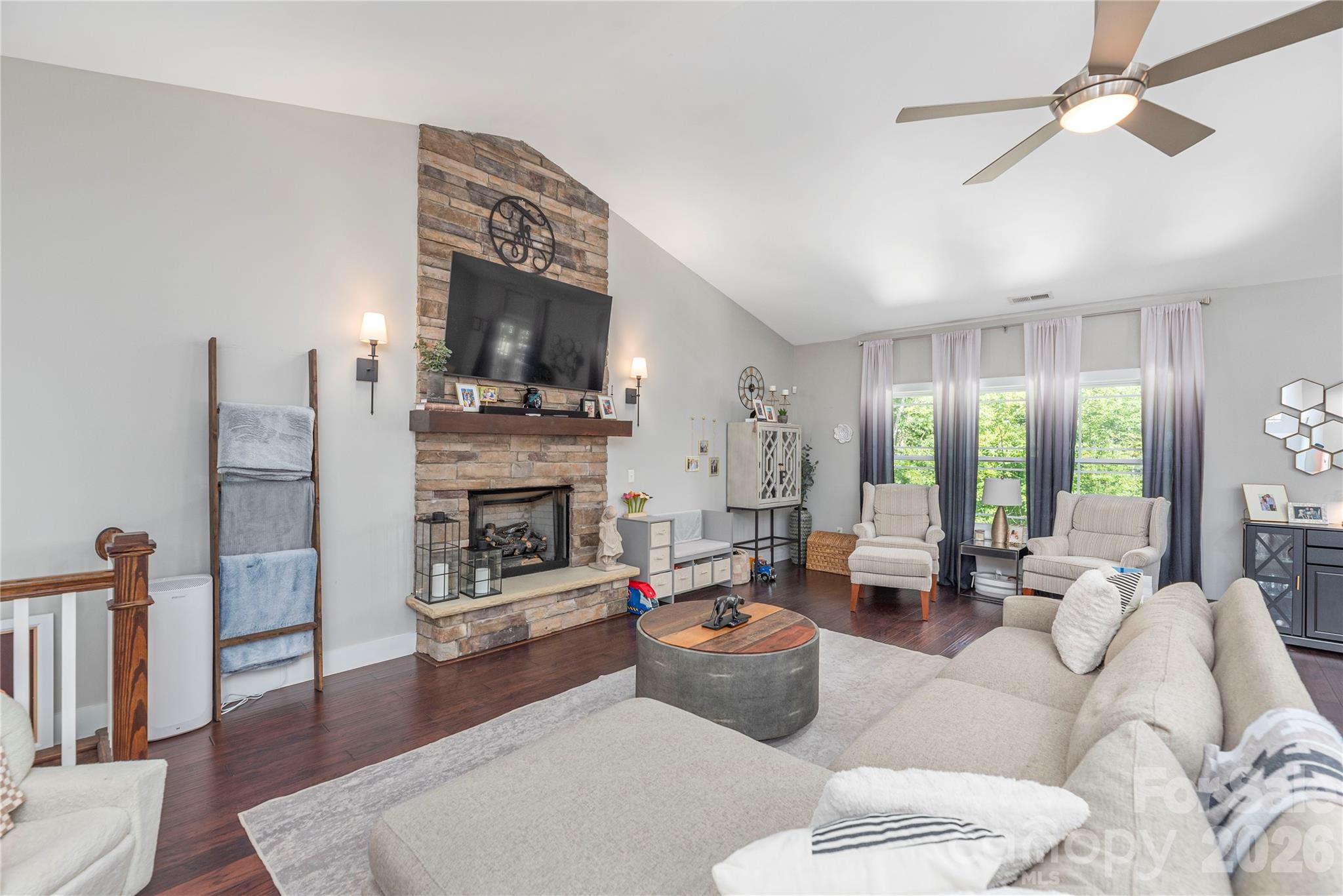 348 Olivet Lane Fletcher, NC 28732 - Photo 4 of 39 a living room with furniture a fireplace and a flat screen tv