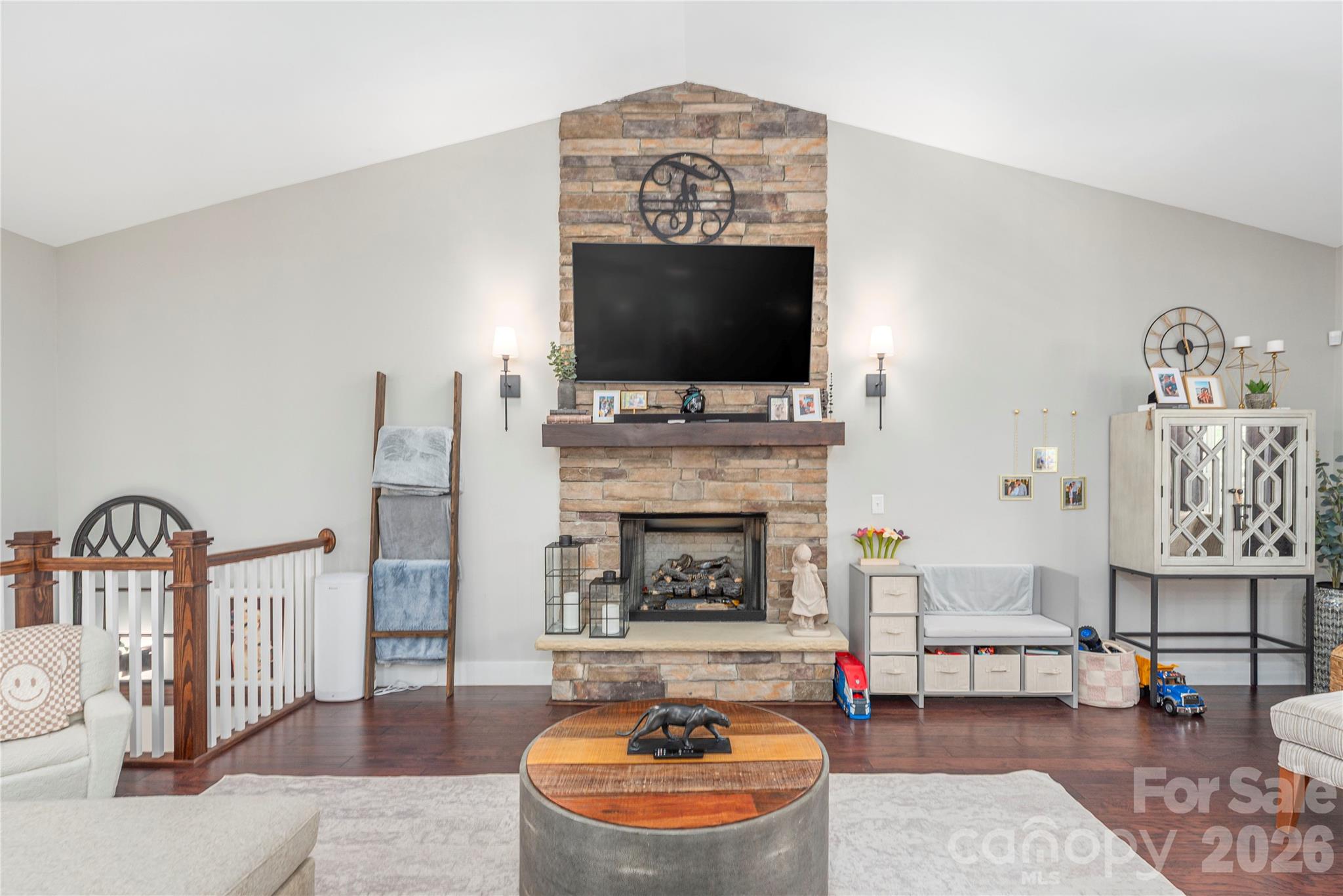 348 Olivet Lane Fletcher, NC 28732 - Photo 6 of 39 a living room with furniture a flat screen tv and a fireplace