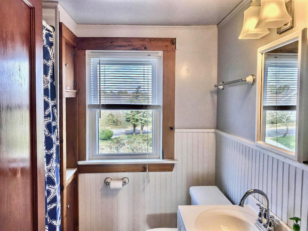 345 Shurtleff Road Eastham, MA 02642 - Photo 12 of 23 a view of a door and a bathtub in a bathroom