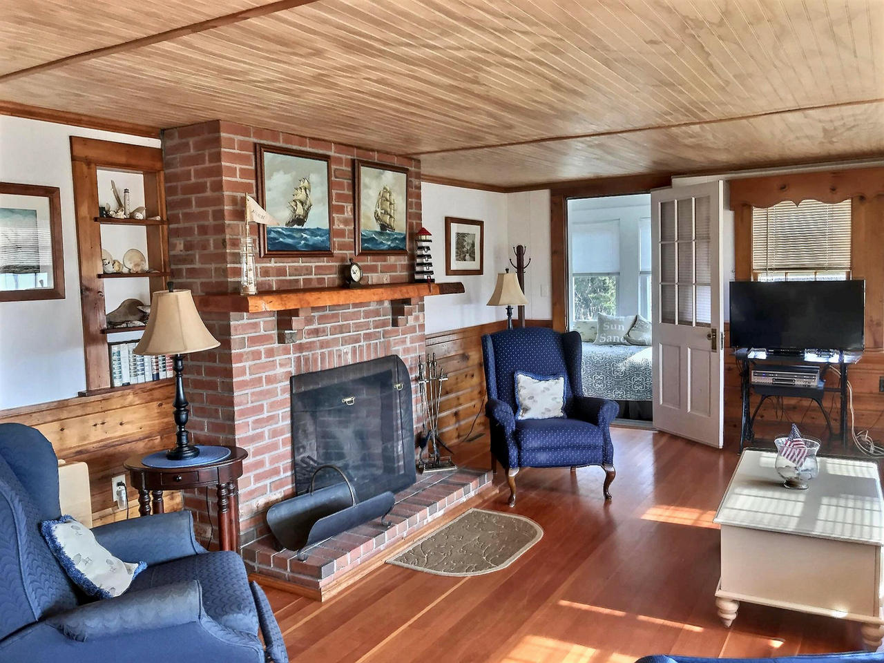 345 Shurtleff Road Eastham, MA 02642 - Photo 10 of 23 a living room with furniture and a fireplace