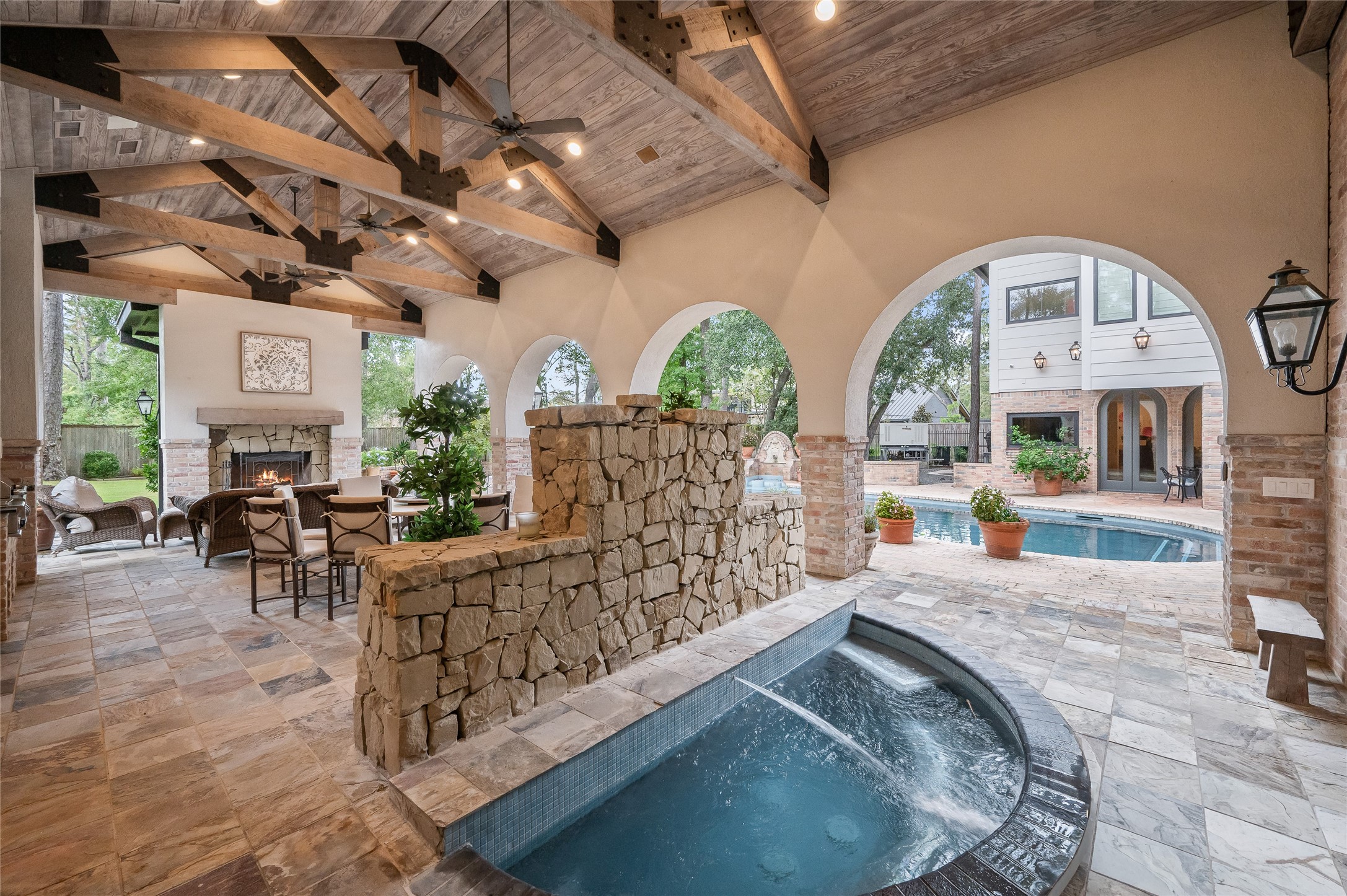 11518 Shadow Way Street Houston, TX 77024 - Photo 47 of 50 Nestled beneath the pavilion, the hot tub features a calming water feature and enjoys direct access from the primary suite, creating a spa-like private escape.