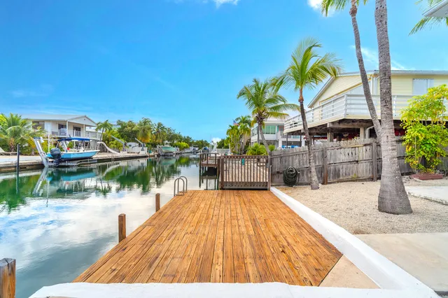 a view of swimming pool with outdoor seating and a garden