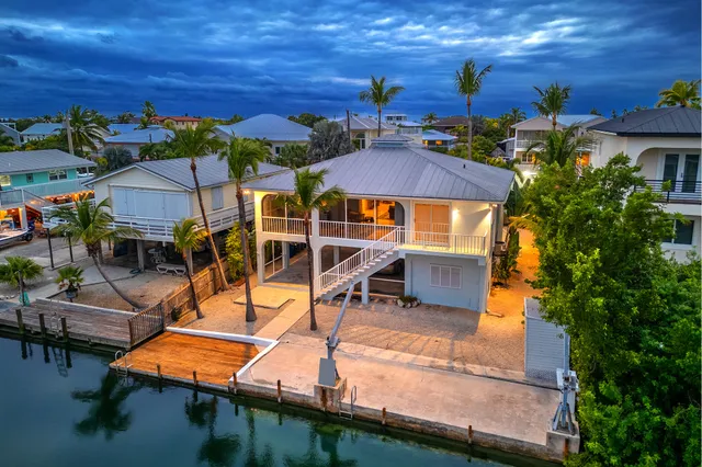 an aerial view of multiple houses with a swimming pool