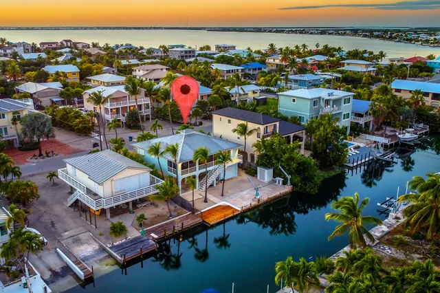 an aerial view of a houses and an outdoor space