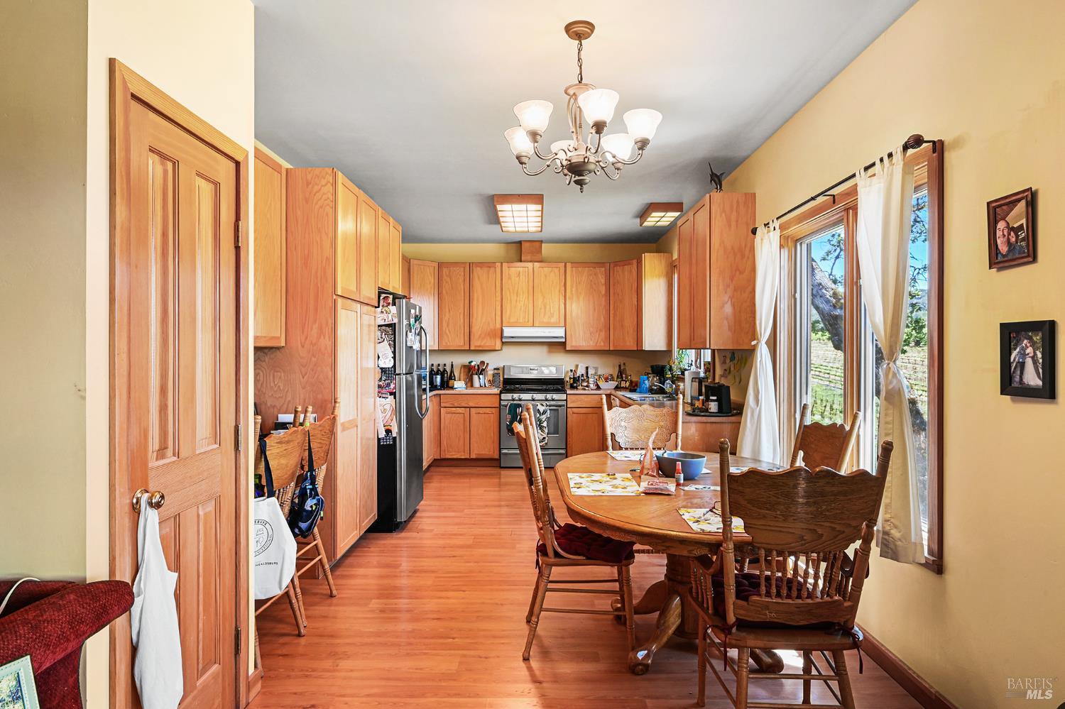 5143 Dry Creek Road Healdsburg, CA 95448 - Photo 85 of 85 a view of a dining room with furniture window and wooden floor