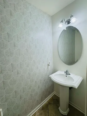a bathroom with a sink a mirror and vanity