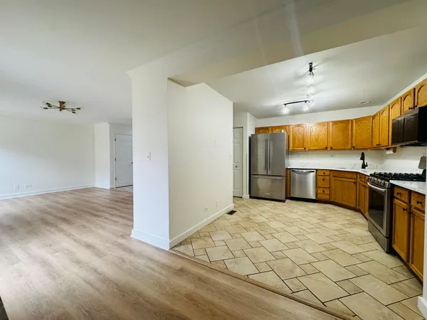 a view of a kitchen with a sink and a refrigerator