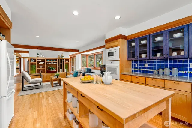a large white kitchen with a large window