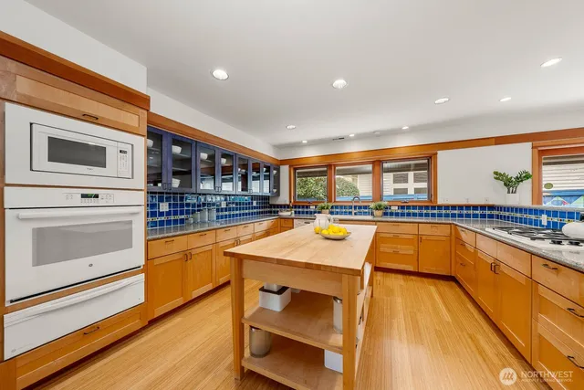 a kitchen with stainless steel appliances granite countertop a stove and a sink