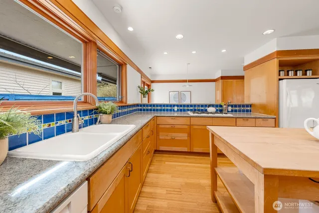 a large kitchen with stainless steel appliances granite countertop a large counter top and a stove