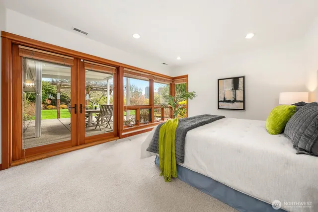 a bedroom with a large bed and a large window