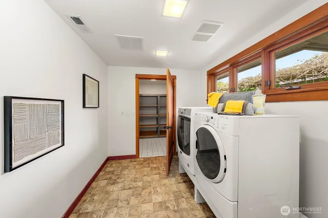 a view of a patio with a table and chairs under an umbrella