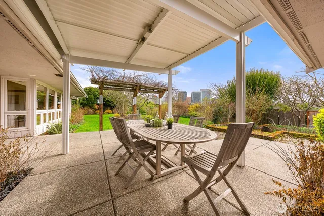a building outdoor space with patio furniture and garden