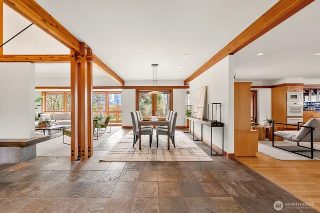 a dining room with furniture and large glass door
