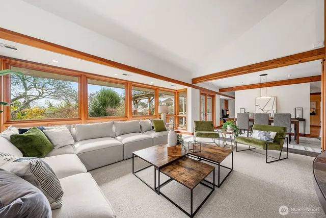 a living room with furniture and a floor to ceiling window