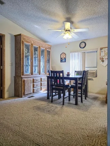 a view of a dining room with furniture and chandelier