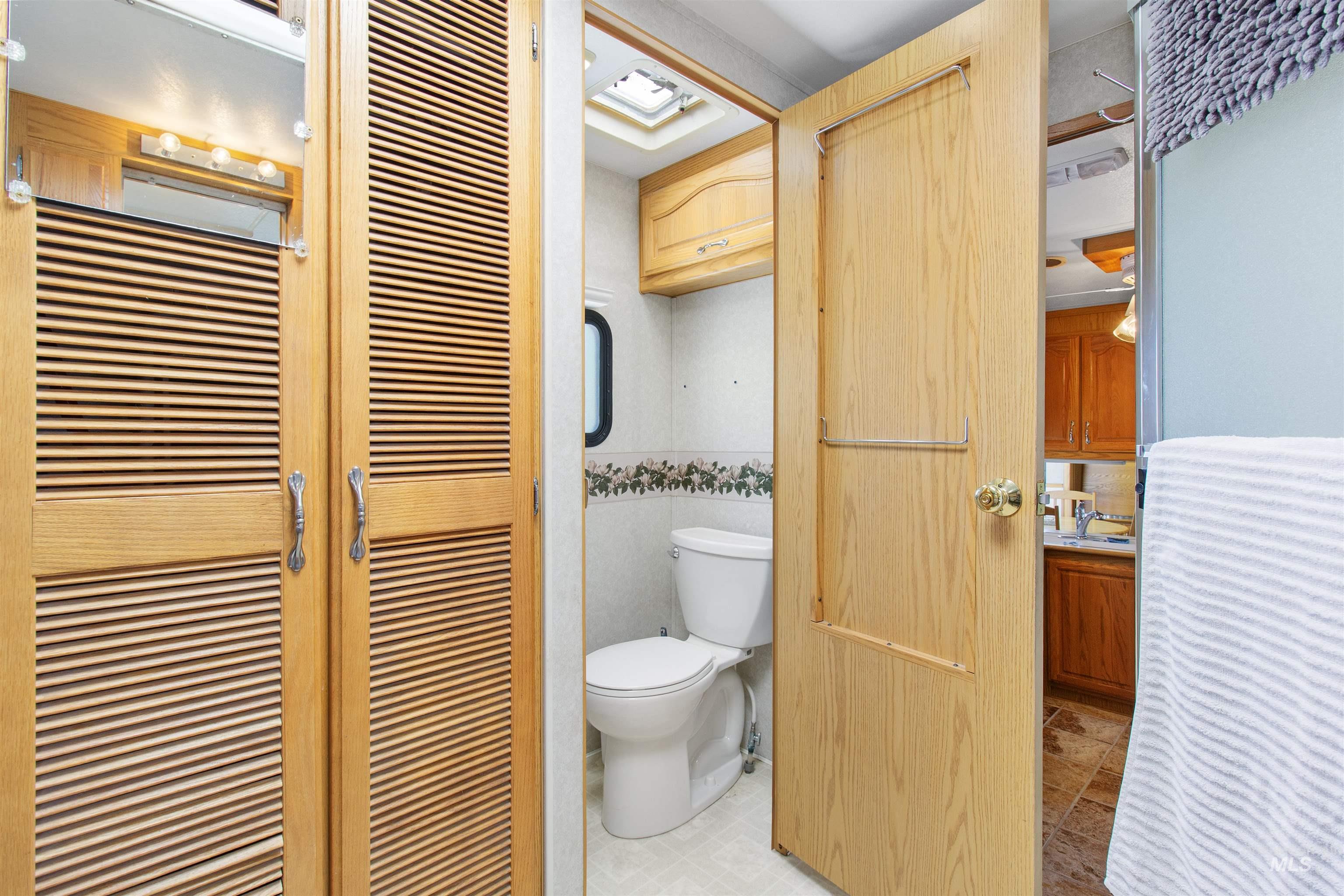 106 West Magic Road Shoshone, ID 83352 - Photo 27 of 45 Light wood louvered doors providing access to a vanity area with overhead lighting