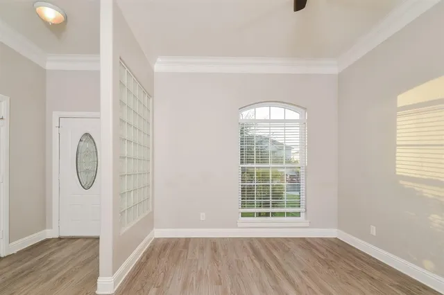 a view of a livingroom with wooden floor and window
