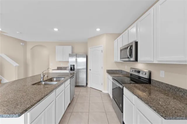 a kitchen with granite countertop a stove and a sink