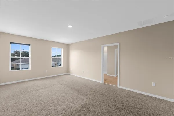 an empty room with windows and closet