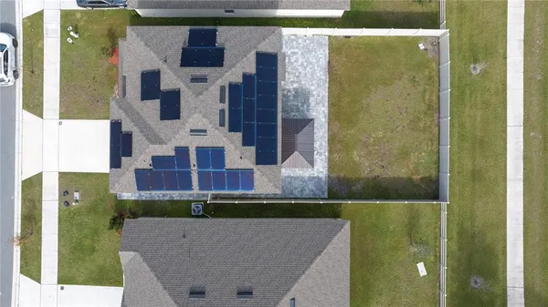 an aerial view of a house with a swimming pool