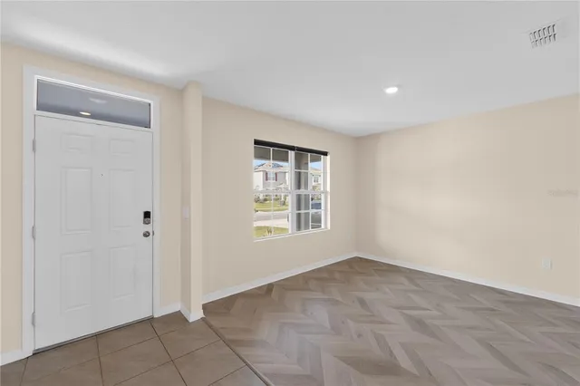 a large kitchen with a stove a sink a microwave a counter top space and cabinets