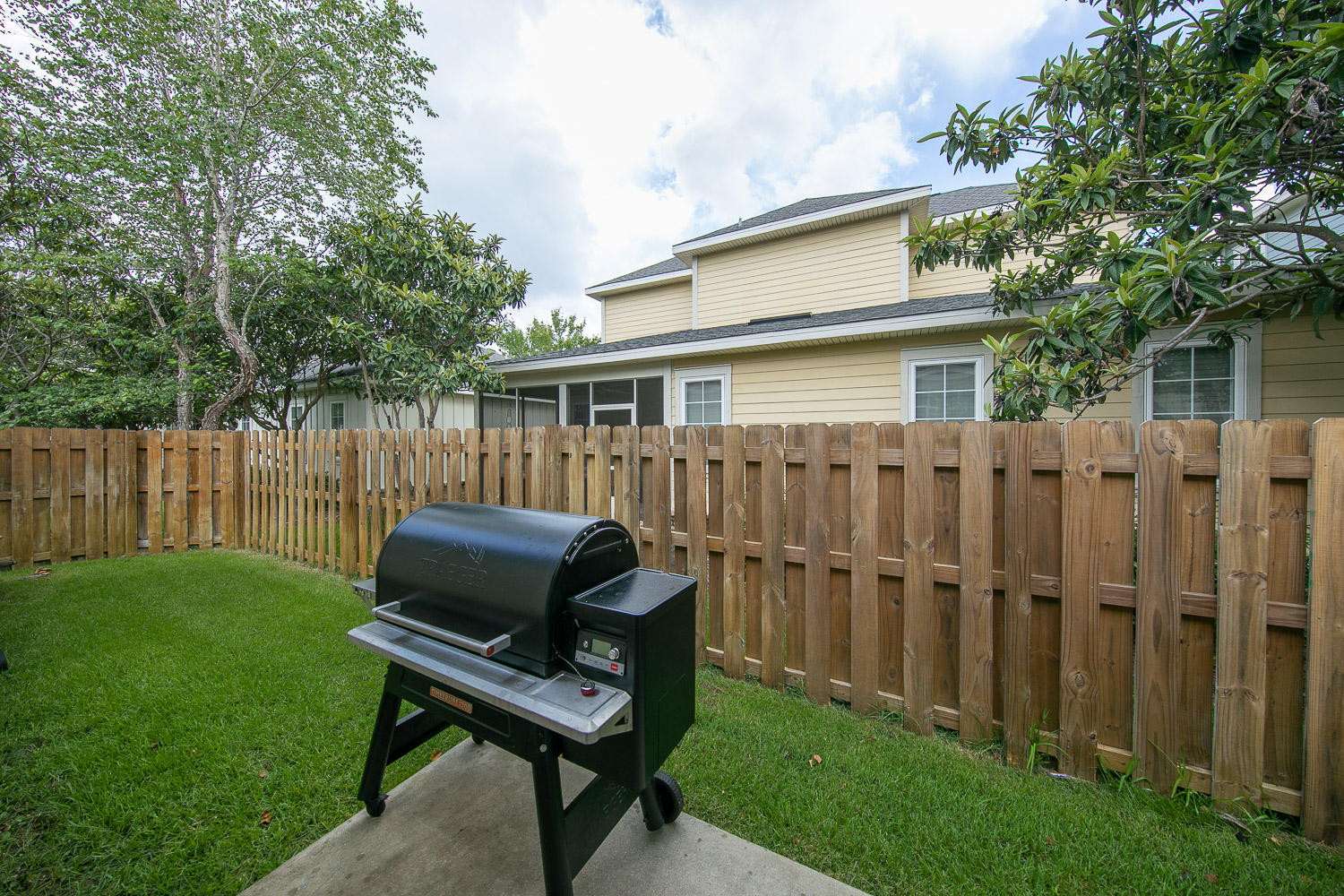 222 South Zander Way Santa Rosa Beach, FL 32459 - Photo 20 of 31 a view of a backyard with chair and wooden fence