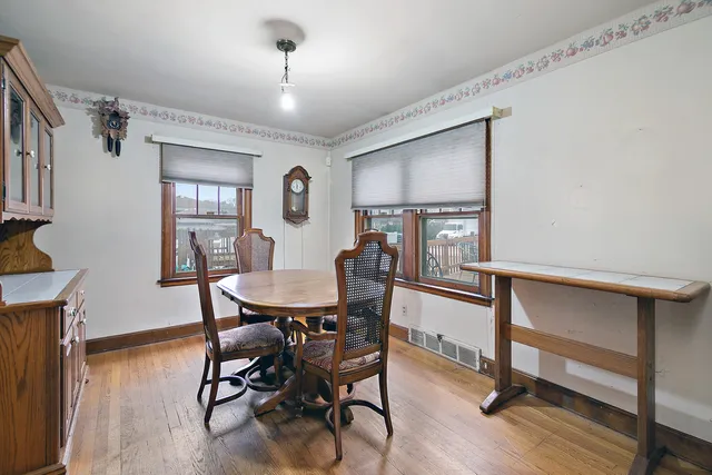 a view of a dining room with furniture and wooden floor