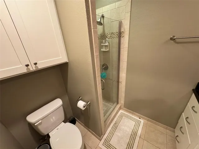 a bathroom with a toilet and a shower