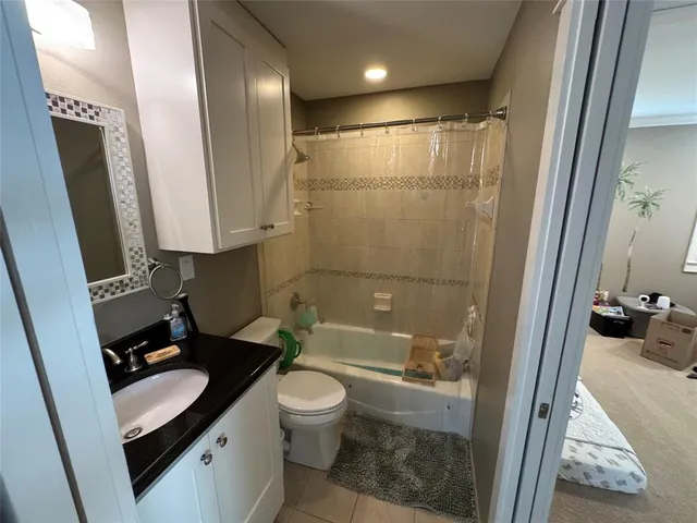 a bathroom with a sink a toilet a mirror and shower