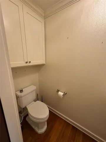 a white toilet sitting next to a small sink