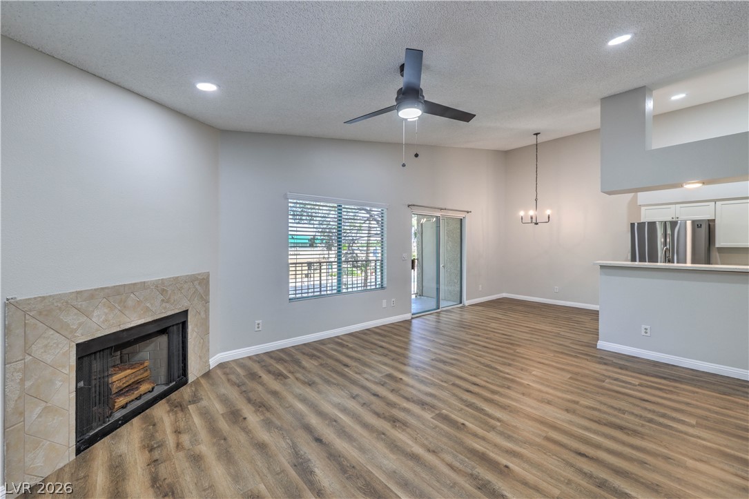 1575 West Warm Springs Road, Unit 322 Henderson, NV 89014 - Photo 7 of 25 Bright and open living space with sleek flooring and a cozy fireplace, perfect for relaxation.