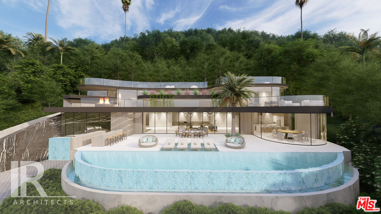 22411 Pacific Coast Highway Malibu, CA 90265 - Photo 3 of 5 a view of a house with backyard sitting area and garden