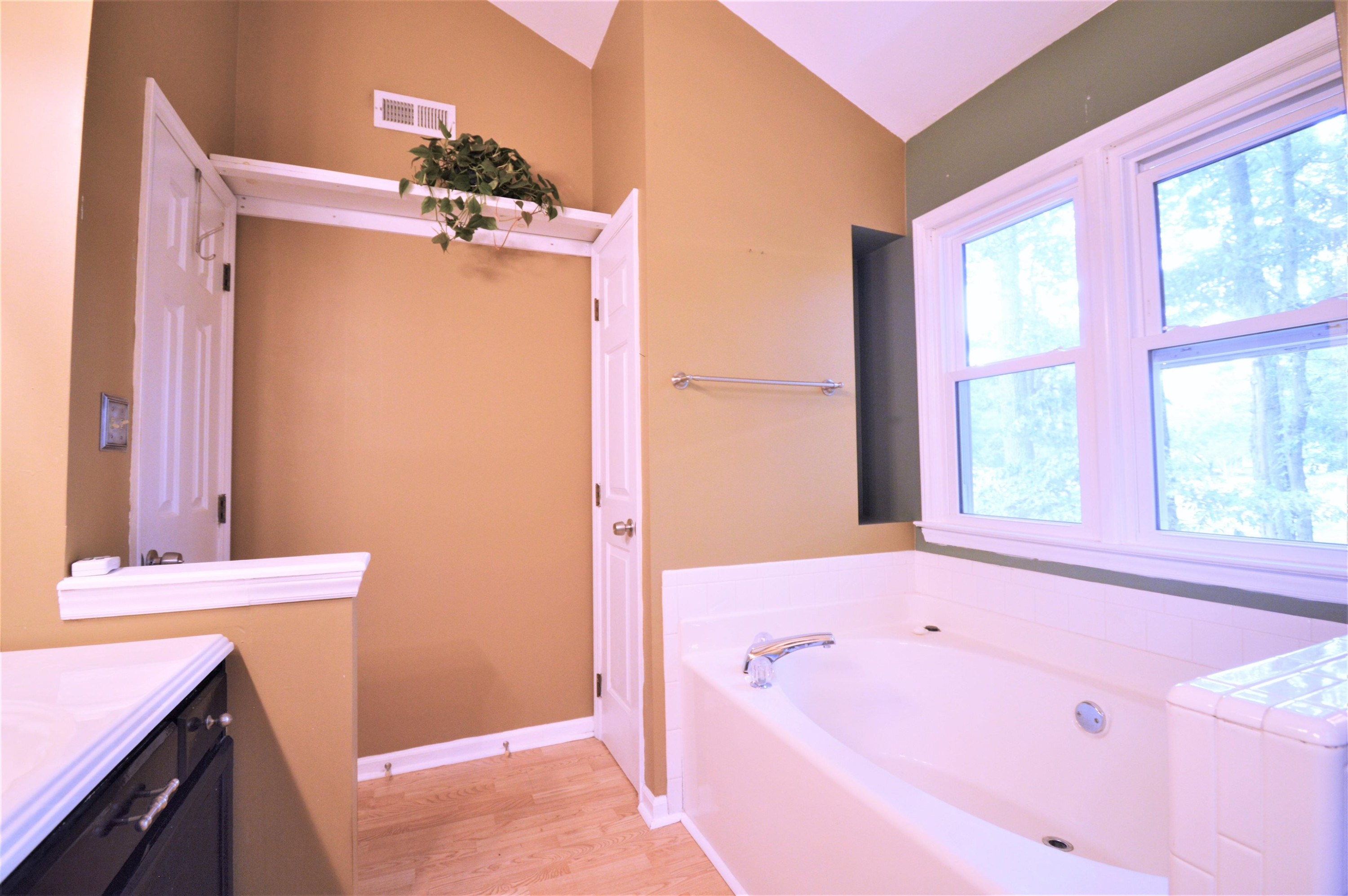 4965 Royal Adelaide Way Raleigh, NC 27604 - Photo 18 of 41 The master bath has a linen closet and a decorative niche. The flooring is laminate. Master Bath/Spa