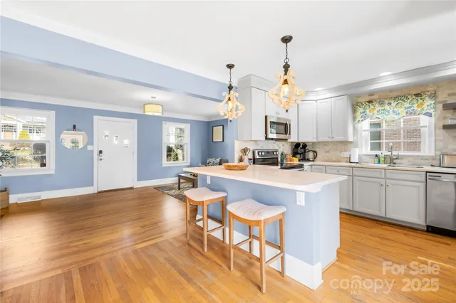 a living room with kitchen island granite countertop furniture and a fireplace