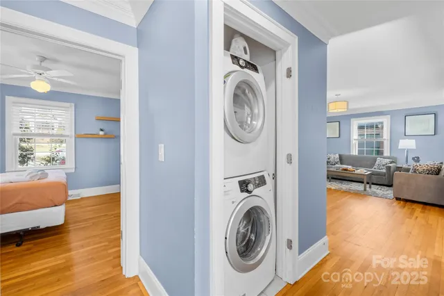 a view of a bedroom with washer and dryer