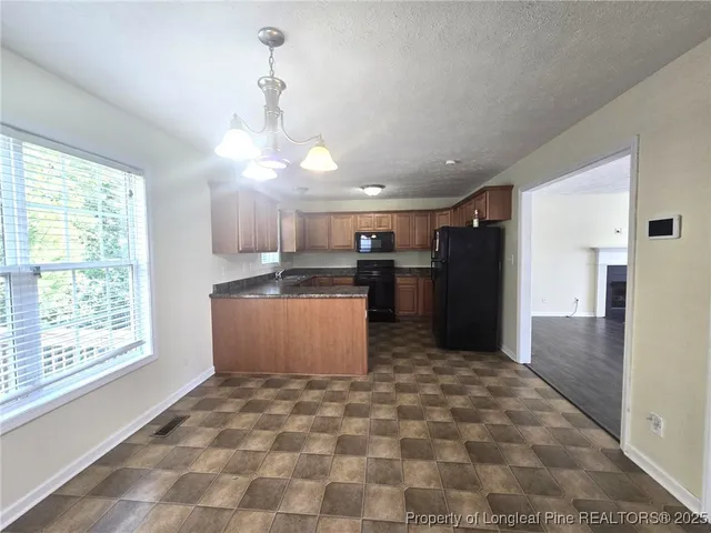 a view of a hallway with wooden floor and a window