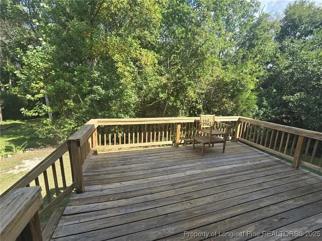 a view of deck with wooden floor and fence