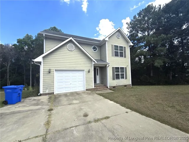 a front view of a house with a garage