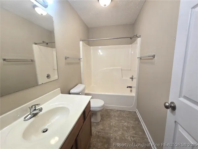 an empty room with closet and a chandelier fan