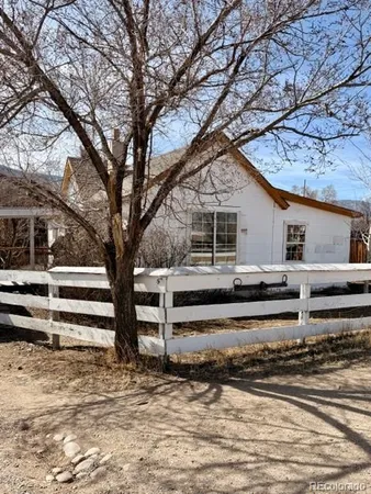 a view of a house with a large tree