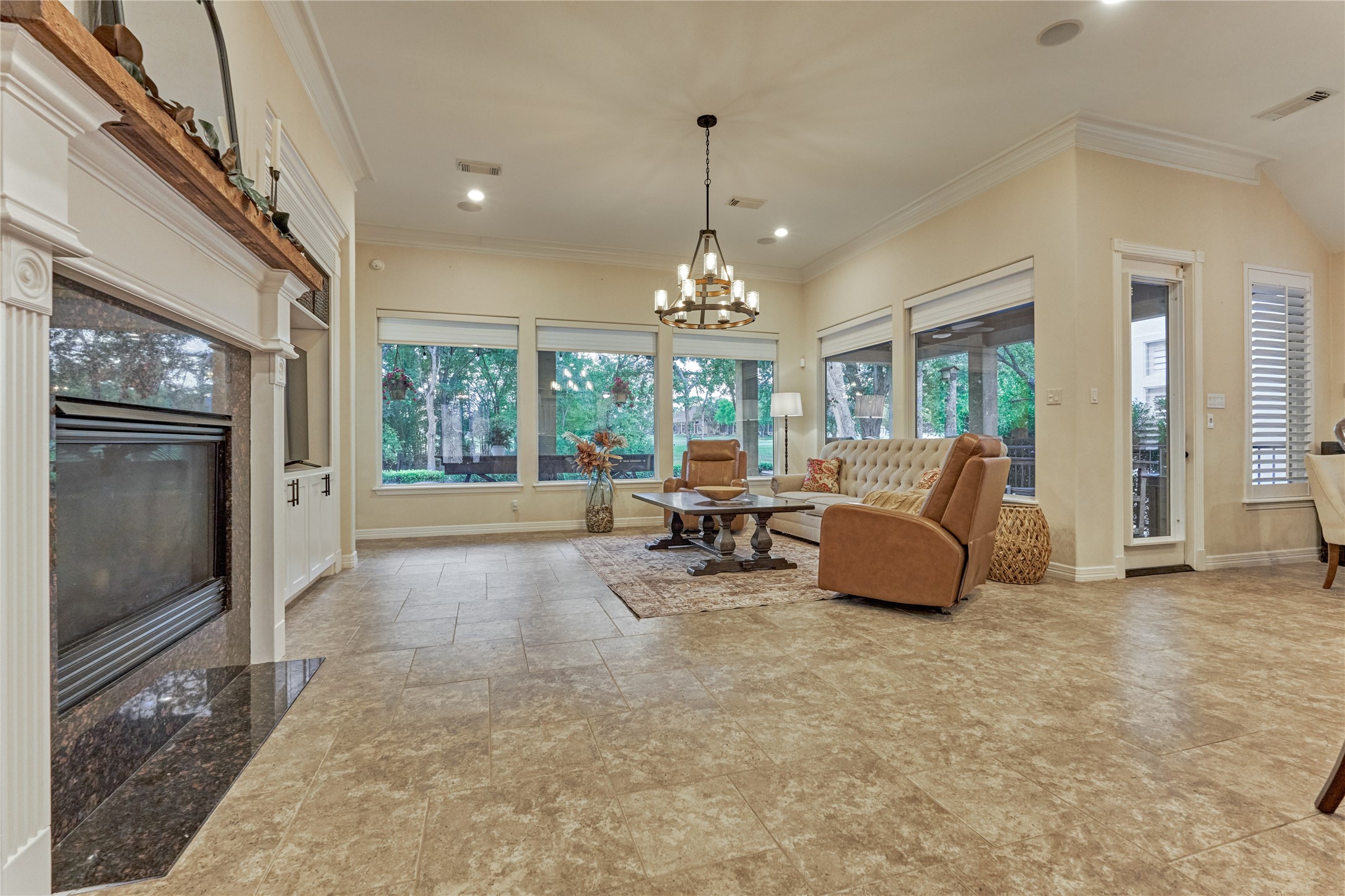 203 Monterrey Road East Montgomery, TX 77356 - Photo 11 of 50 The spacious living room features a warm fireplace with a new mantle that compliments the crisp white trim work. New window coverings highlight the large picture windows.